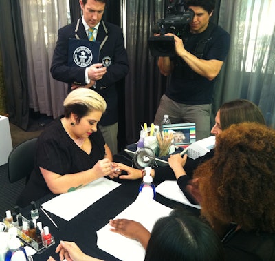 2 12 2014 Naja Polishing Nails With Guinness World Records Representative Philip Robertson Looking On