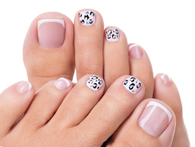 Beautiful woman’s nails of legs with beautiful french manicure