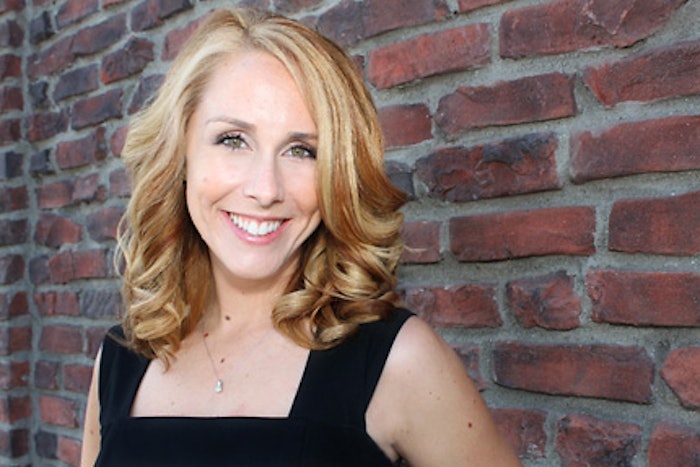 Valorie Headshot Brick Backgroung