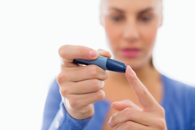 Woman taking her own blood sugar