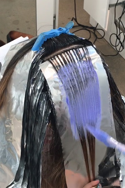 Formula and foils being applied to hair