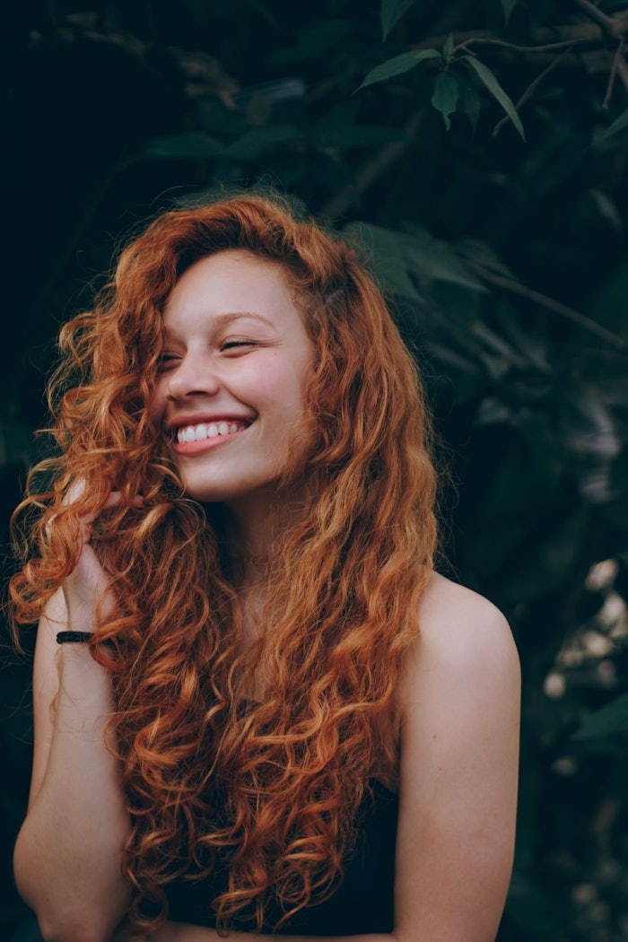 Canva Smiling Woman With Red Hair Tomaz Barcellos Copy