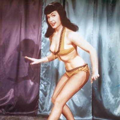 Bettie Page in a thick, fringe hairstyle.