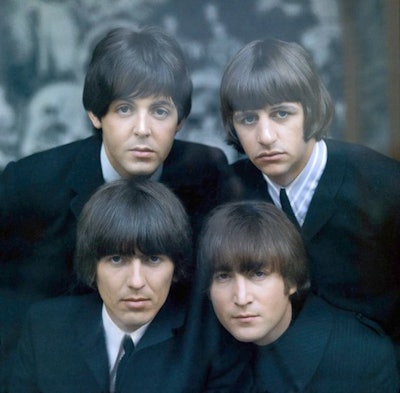 The Beatles wearing mop tops.