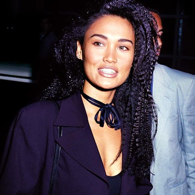 Tia Carrere wears a crimped hairstyle.