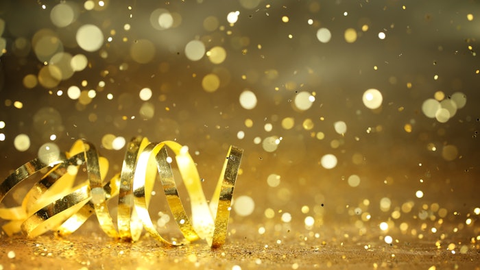 Photo of gold party streamers and confetti.