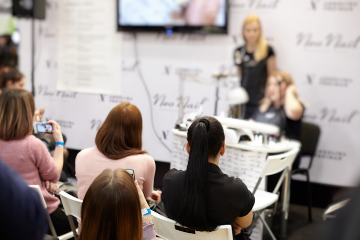 Attendees viewing a nail presentation