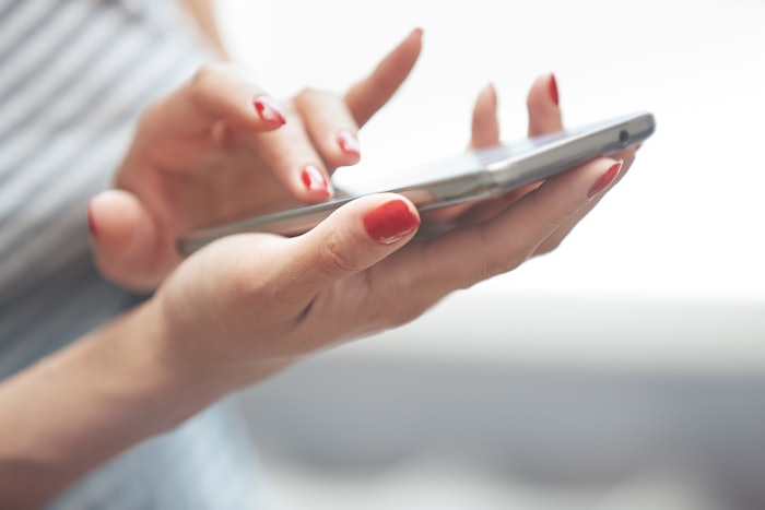 Woman with manicured nails, filling out survey