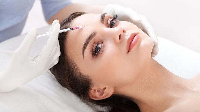 woman receiving Botox injection in forehead