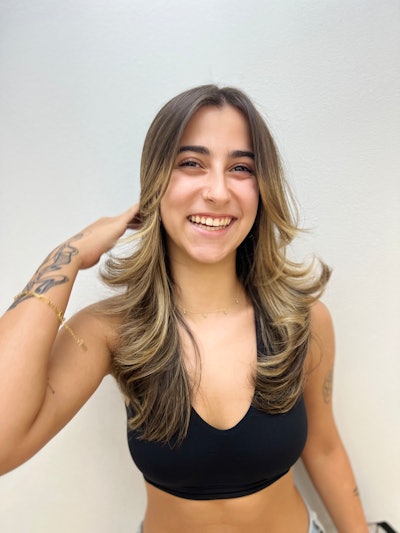 Latina hair styled with large curls to create volume