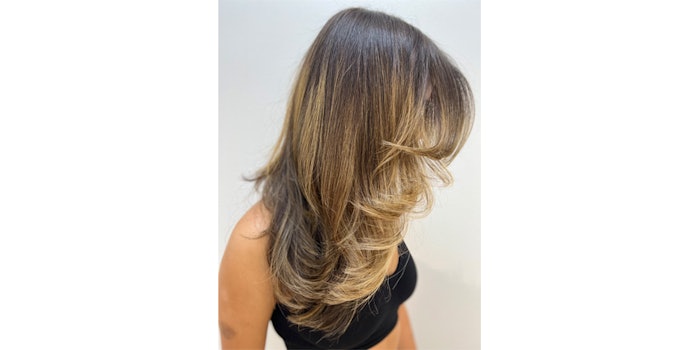 Latina hair styled with large curls to create volume