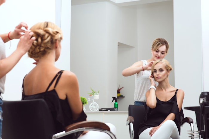 Hair stylist in a salon suite working on a client