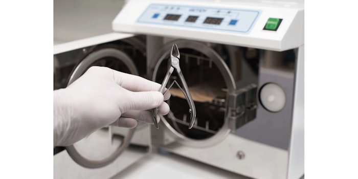 Hand holding a tool before it is put in an autoclave.