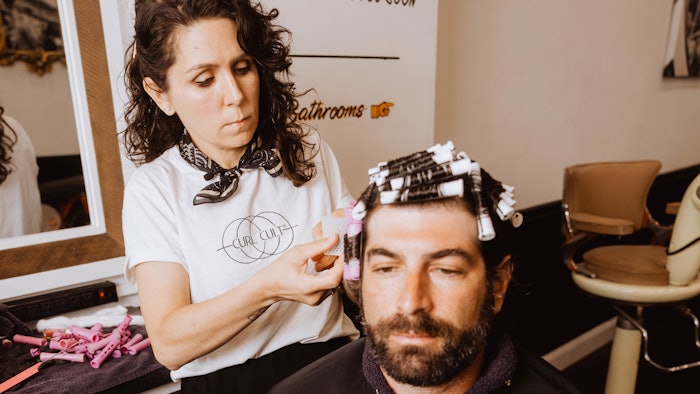 Male client receiving a perm