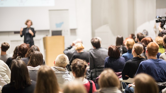 woman presenting at conference