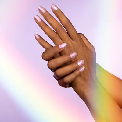 The limited edition Over the Rainbow nail strips feature colorful rainbows on a purple-flashed white shimmer base.