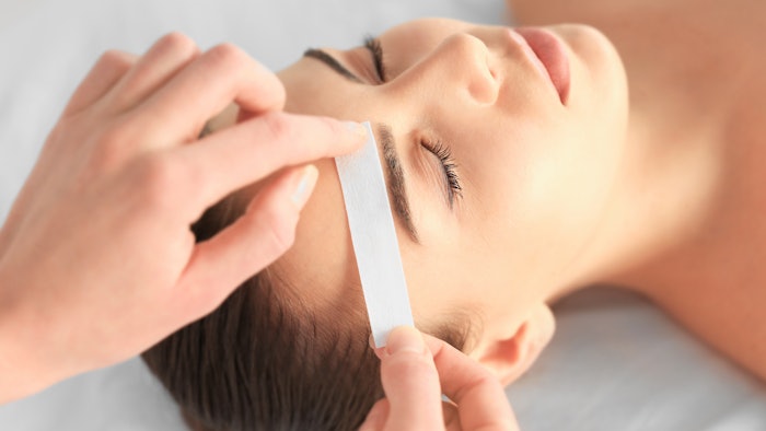 woman getting eyebrows waxed