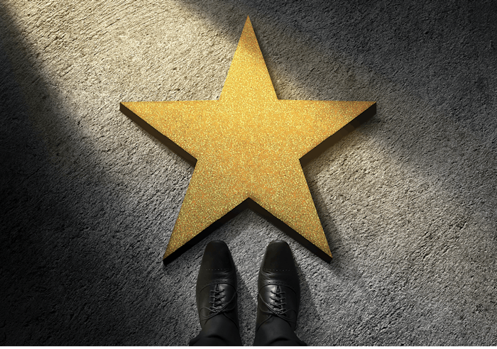business person standing in front of star