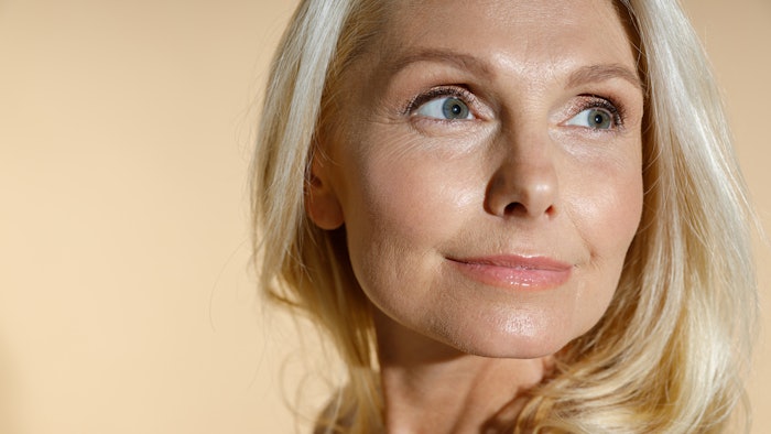 older woman with healthy skin posing