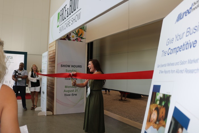 Nailpro Editor-in-Chief Katie Anderson cuts the ribbon to kick off the first day of Face and Body Skin Care Show and Nailpro Nail Show.
