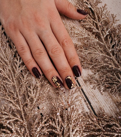 Burgundy manicure with gold foil details
