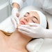 Woman getting face beauty treatment in medical spa center.