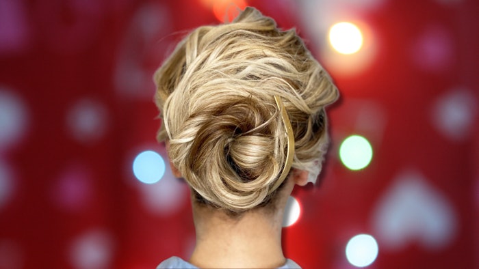 Lindsey Olson (@lindsey.marie.olson), Global Redken Artist and Sam Villa Brand Ambassador, created a gorgeous textured bun that will be the hit of all the holiday parties.