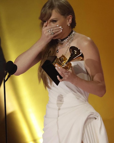 Taylor Swift shows off white nails by Lisa Peña Wong as she accepts her award for Album of the Year for 'Midnights.'