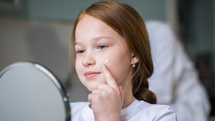 Girl Using Skin Care Lotion Adobe Stock 509704583