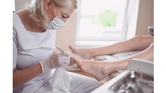 Woman doing a pedicure in a spa
