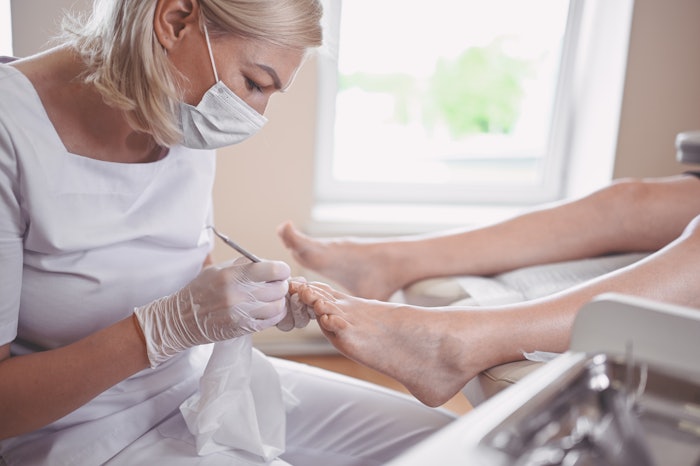 Woman doing a pedicure in a spa