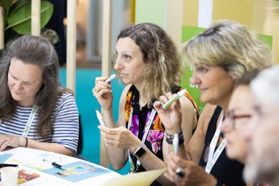 The dsm-firmenich WPC 2024 booth utilized playful pencils as smelling tools, not to be applied on the skin, for the nose only for attendees to experience scents.