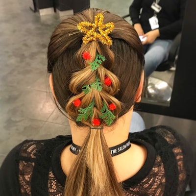Hair braided into a Christmas tree and decorated with a pipe cleaner star.