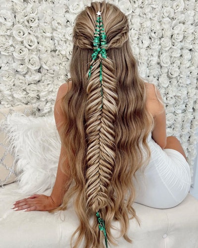 A braided hairstyle decorated with green tinsel.