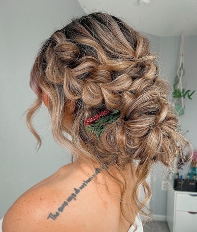 A holiday updo styled with a festive accent braid