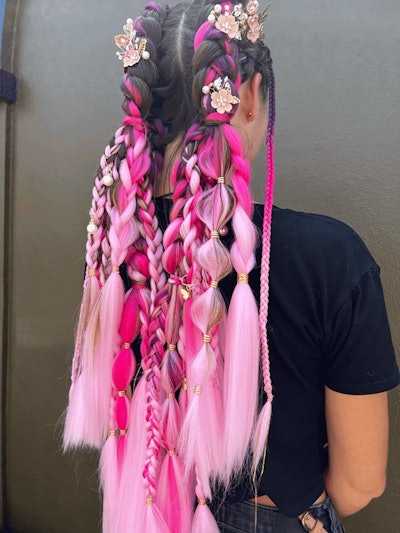 Client wears pink festival braids with floral accessories