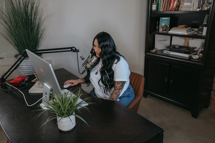 Gina recording an episode of her podcast.