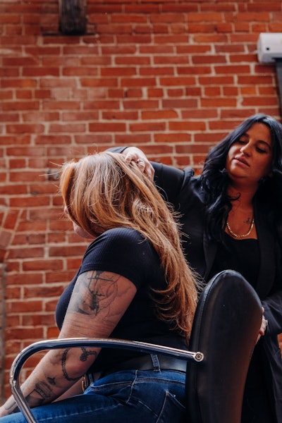 Gina working with a client behind the chair.