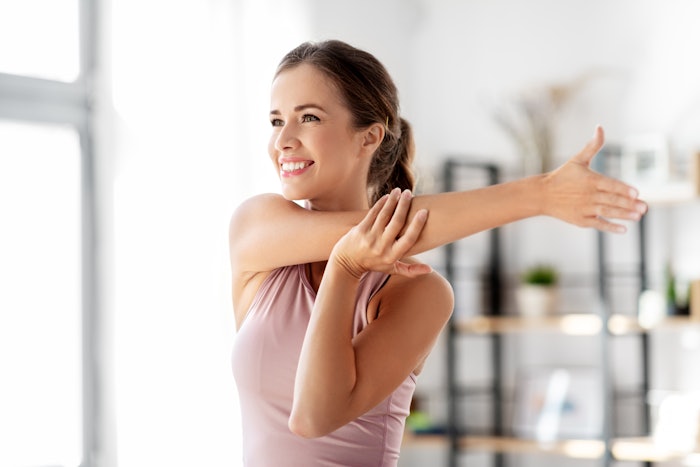 The cross-arm stretch targets your rotator cuff muscles—a group of tendons and muscles around your shoulder joint that hold the bones together.
