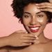 black woman young radiant skin smiling posing