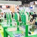 people reviewing entries in the innovation zone glass cubes on pedestals with entries inside each