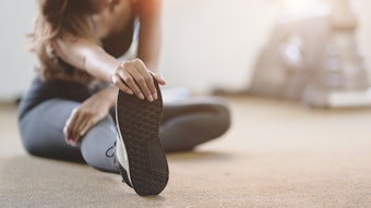 Person stretching by reaching for their foot.