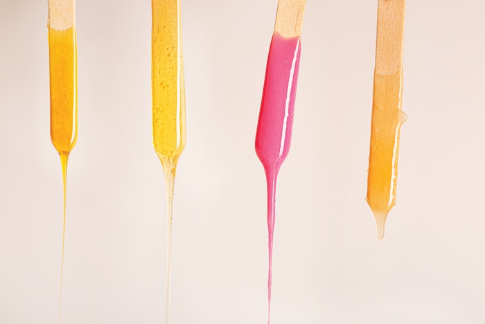 Wax dripping off of four sticks