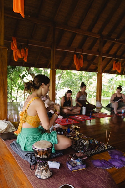 Elizabeth Faye practicing meditation and breathwork at a retreat.