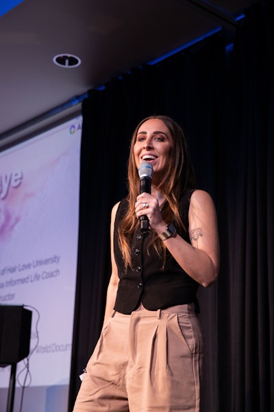 Elizabeth Faye speaking on stage