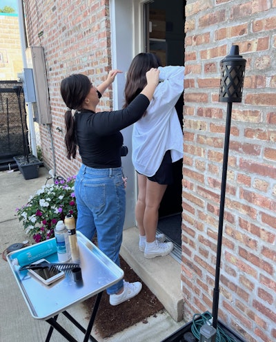 Adele helping a client pose for a picture