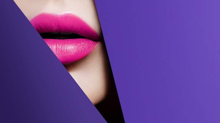 pink lips up close viewed through cut purple paper