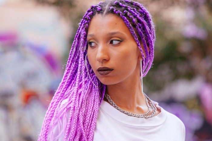 Woman with violet braided hair.