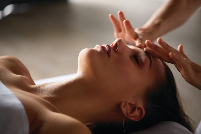 woman getting stress releasing facial massage