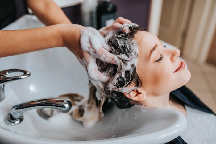 Client getting their hair washed in salon
